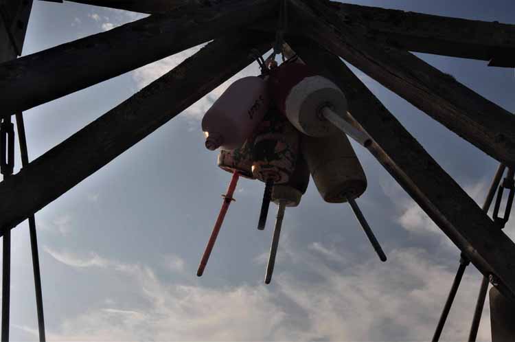 buoys hanging from bridge joist